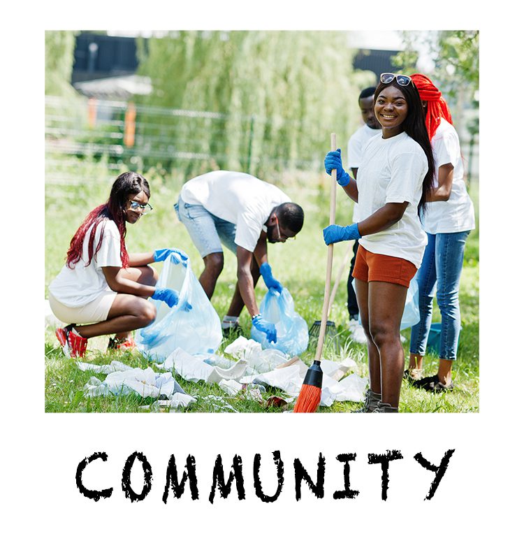 A group of people cleaning up trash on the grass.